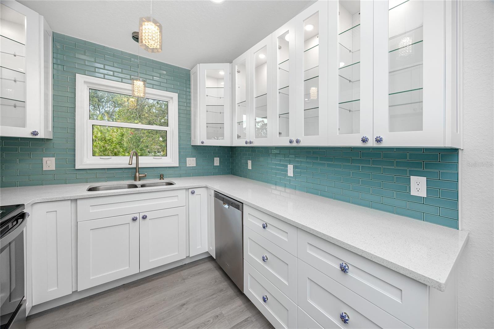 Beautiful full kitchen with stone counters and custom cabinets.
