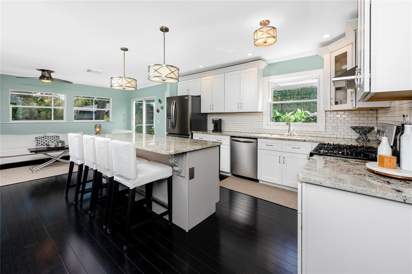 Stunning kitchen in the main house with stone countertops, stainless steel appliances, and lots of natural light.
