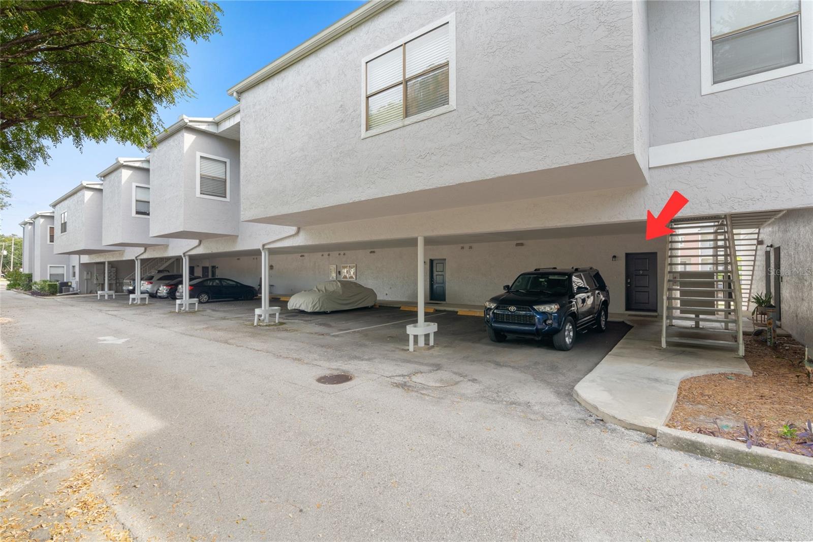Front of unit with covered parking space