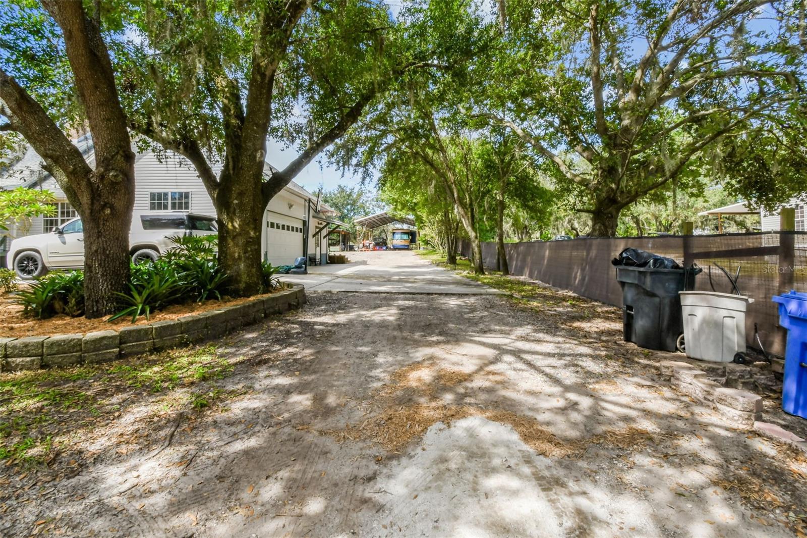 driveway towards garage and back yard