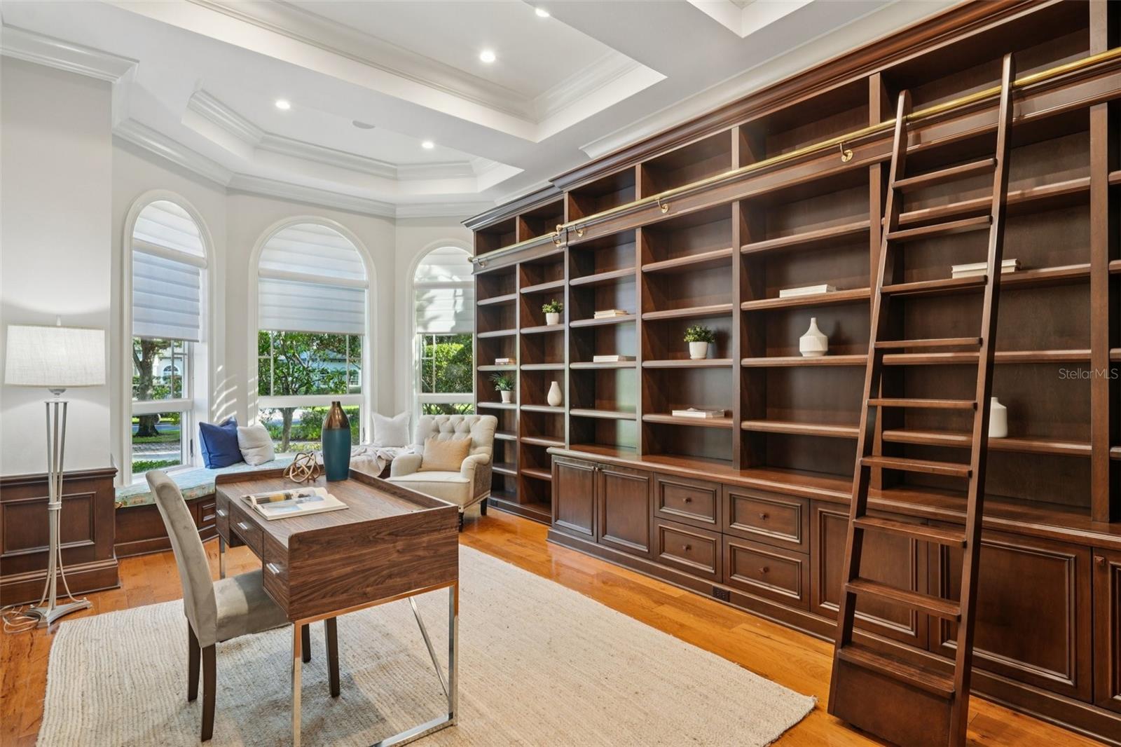 Office with Custom Bookshelves and a Sliding Ladder