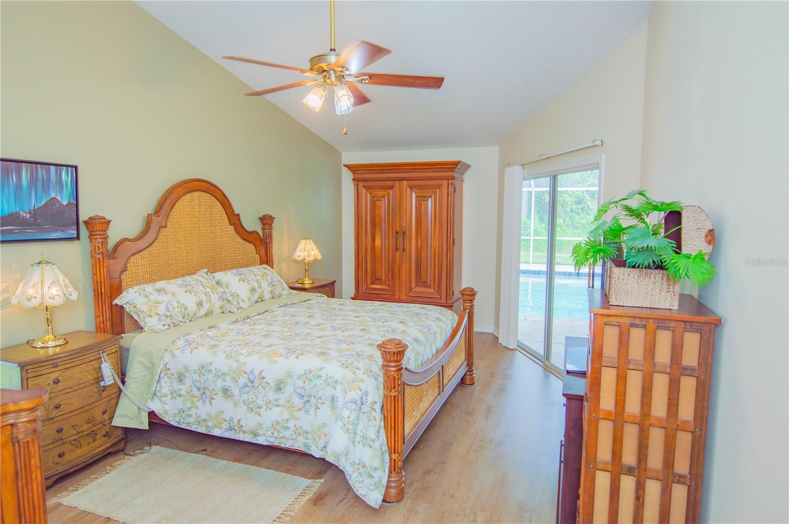 Primary Bedroom with sliders leading to pool area.