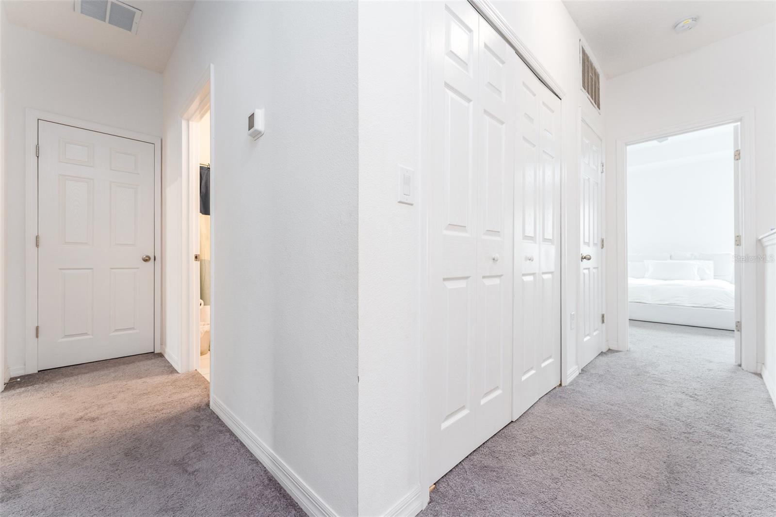 top of the 2nd floor. Linen closet to the left, 2nd bath entry (light on), the laundry closet, HVAC & entrance to the primary bedroom on the right