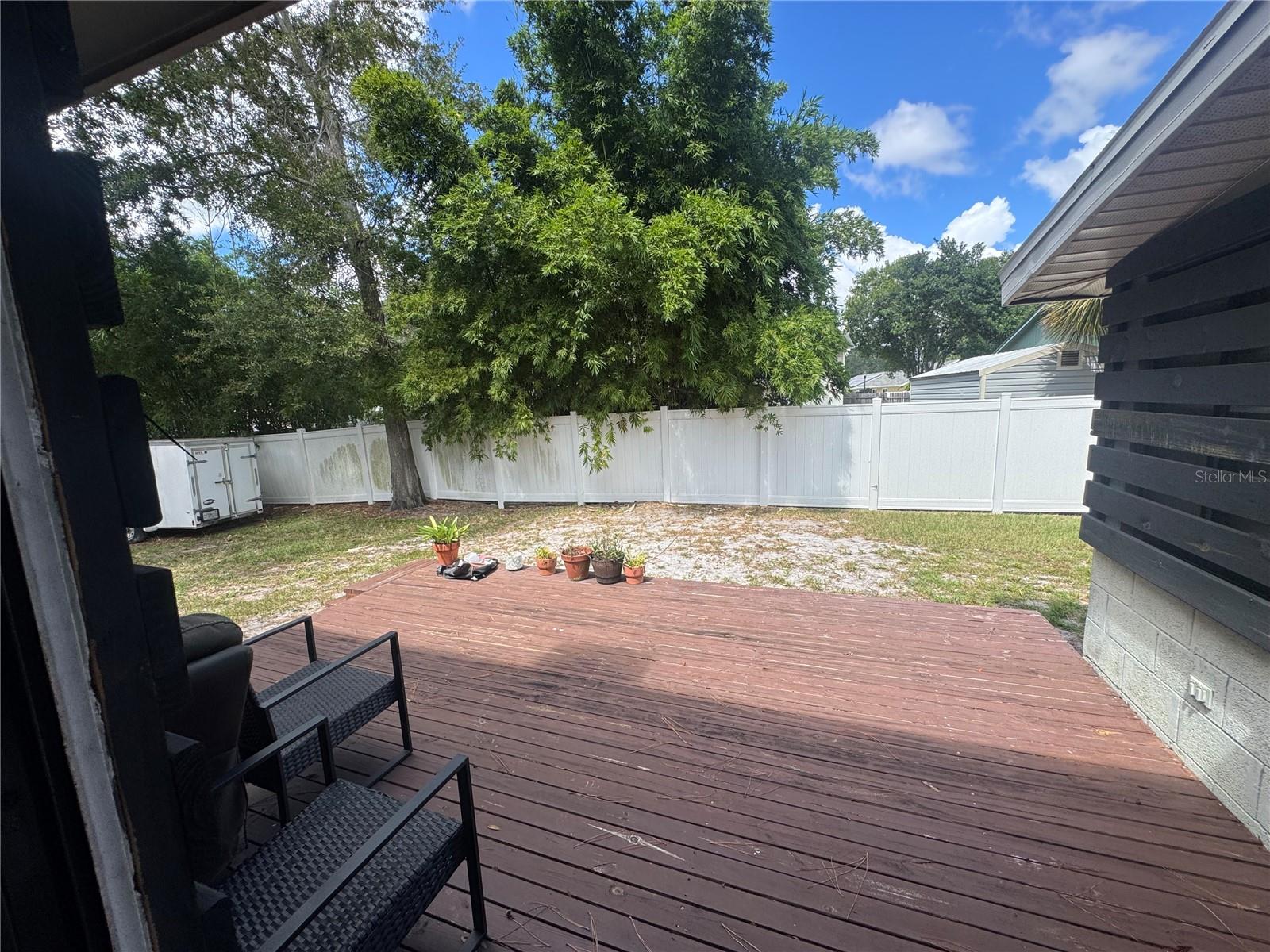 outside yard from sliding glass door; leads to wood deck; fenced back yard