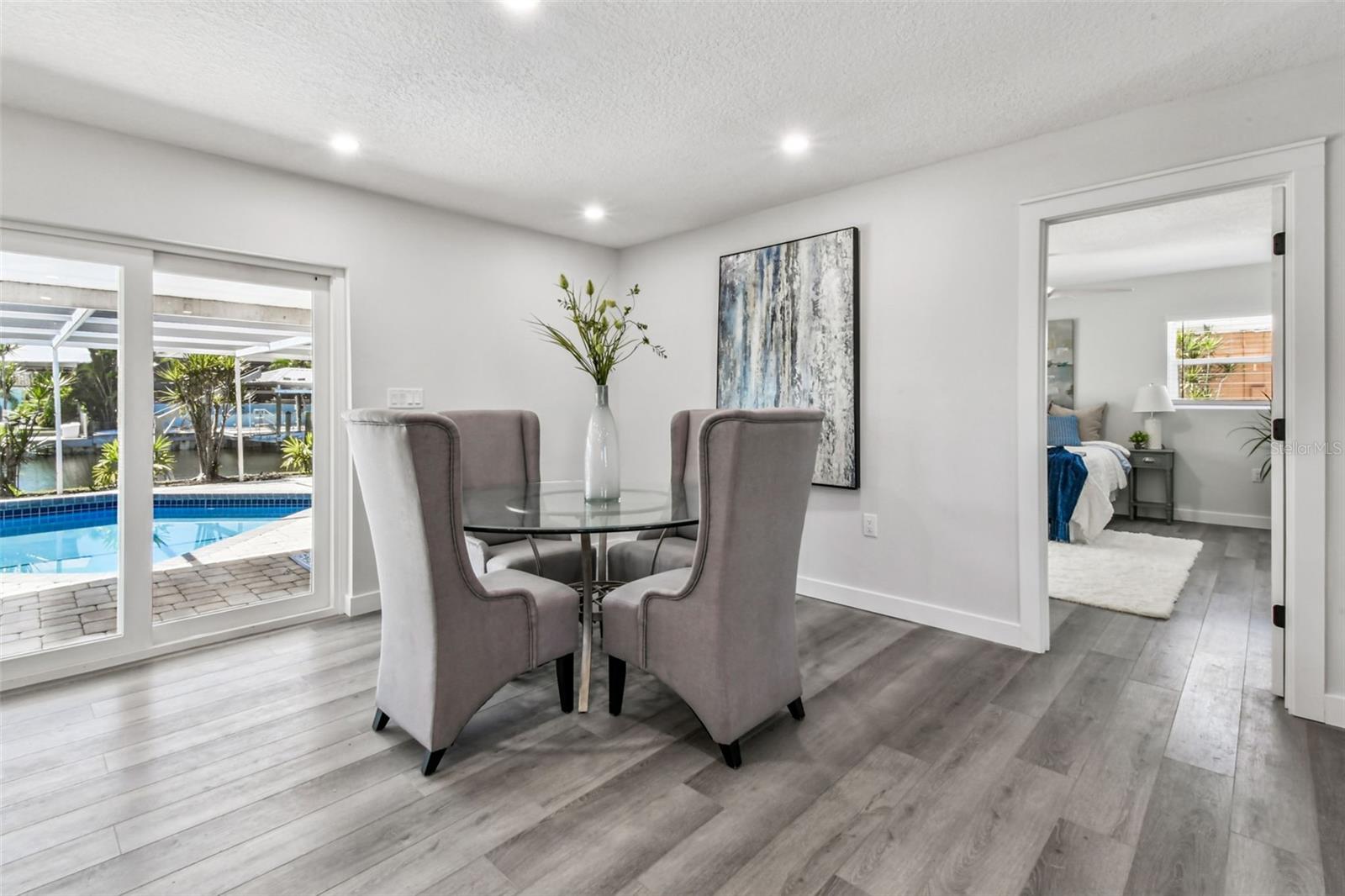 Lovely dining area with views of pool and waterfront!