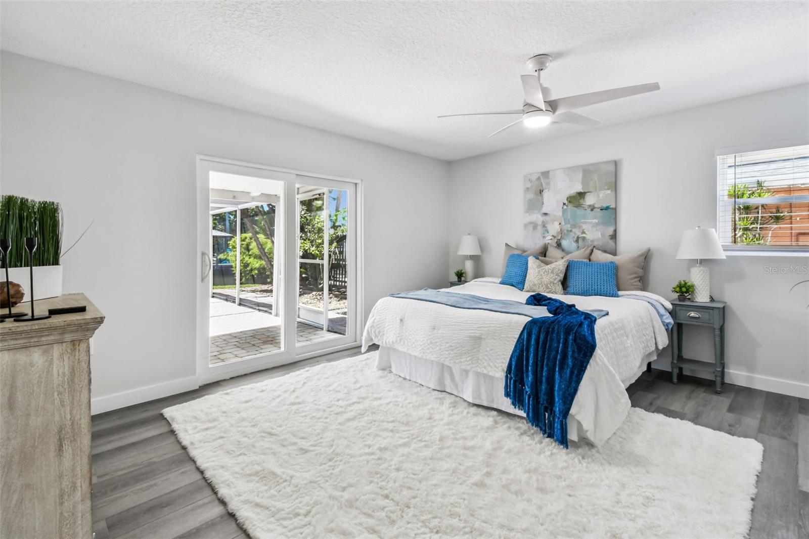 Primary suite is roomy and has beautiful views of the pool and waterfront!