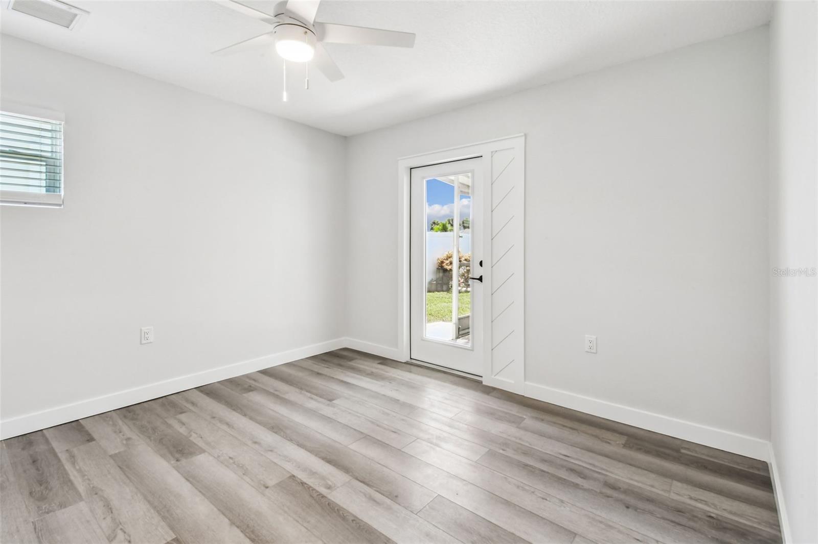 Guest bedroom has pretty new impact door to patio and pool deck/could be a great office too!
