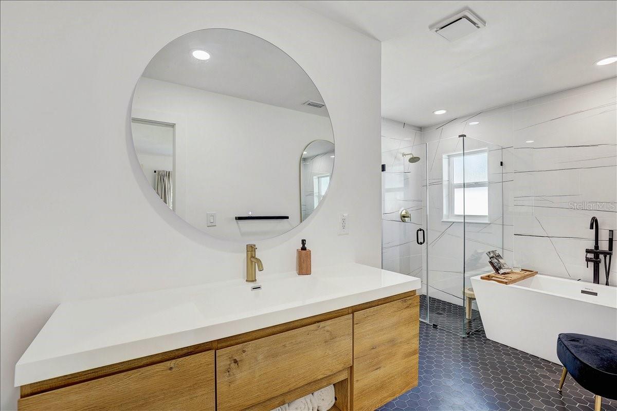 Primary bathroom with separate tun and zero entry/curbless shower