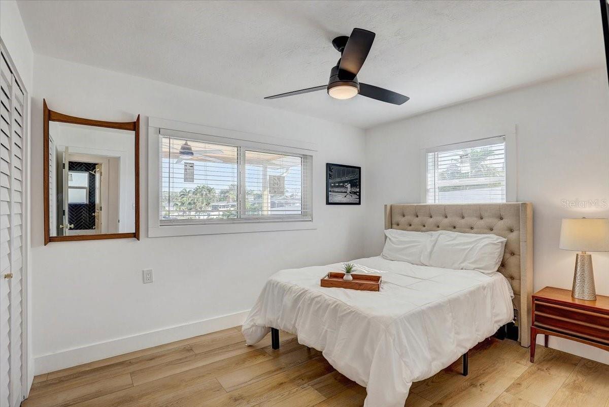 2nd bedroom (queen bed shown) with water views over looking the back patio