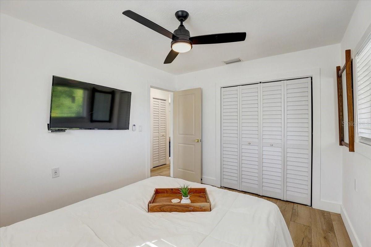 2nd bedroom (55 inch tv shown) and custom closet