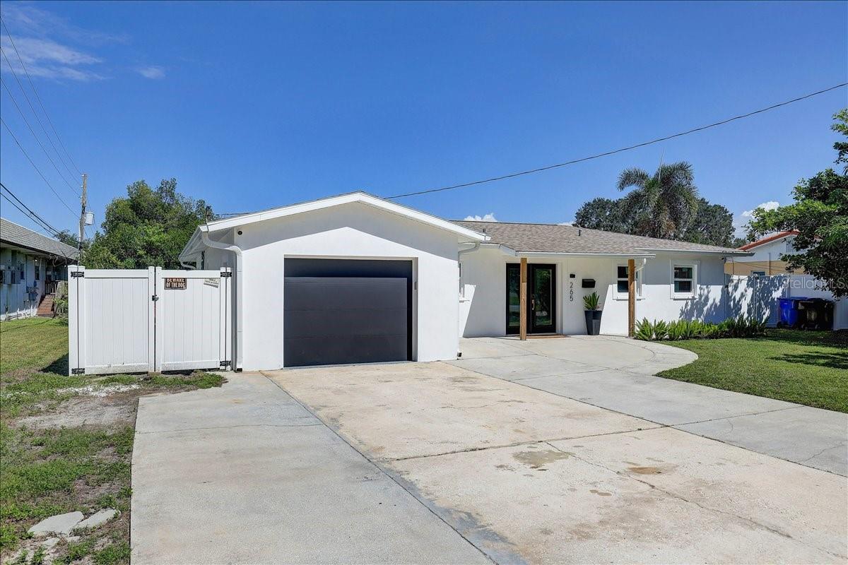 6-8 car driveway with additional trailer parking up the left side of the home behind the double gate