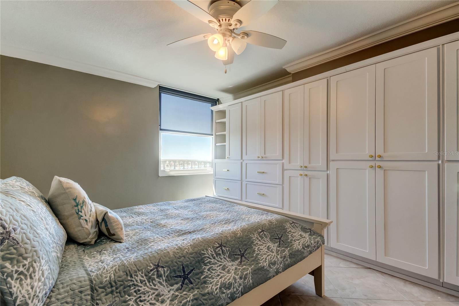 Guest bedroom with built-in closet and storage space