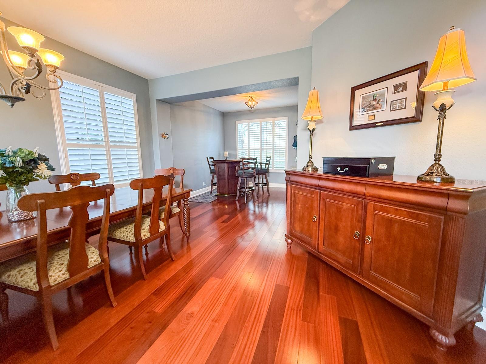 entry and foyer leading into dining area and bar area