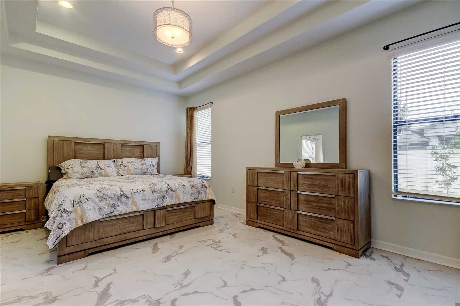 primary bedroom with tray ceilings