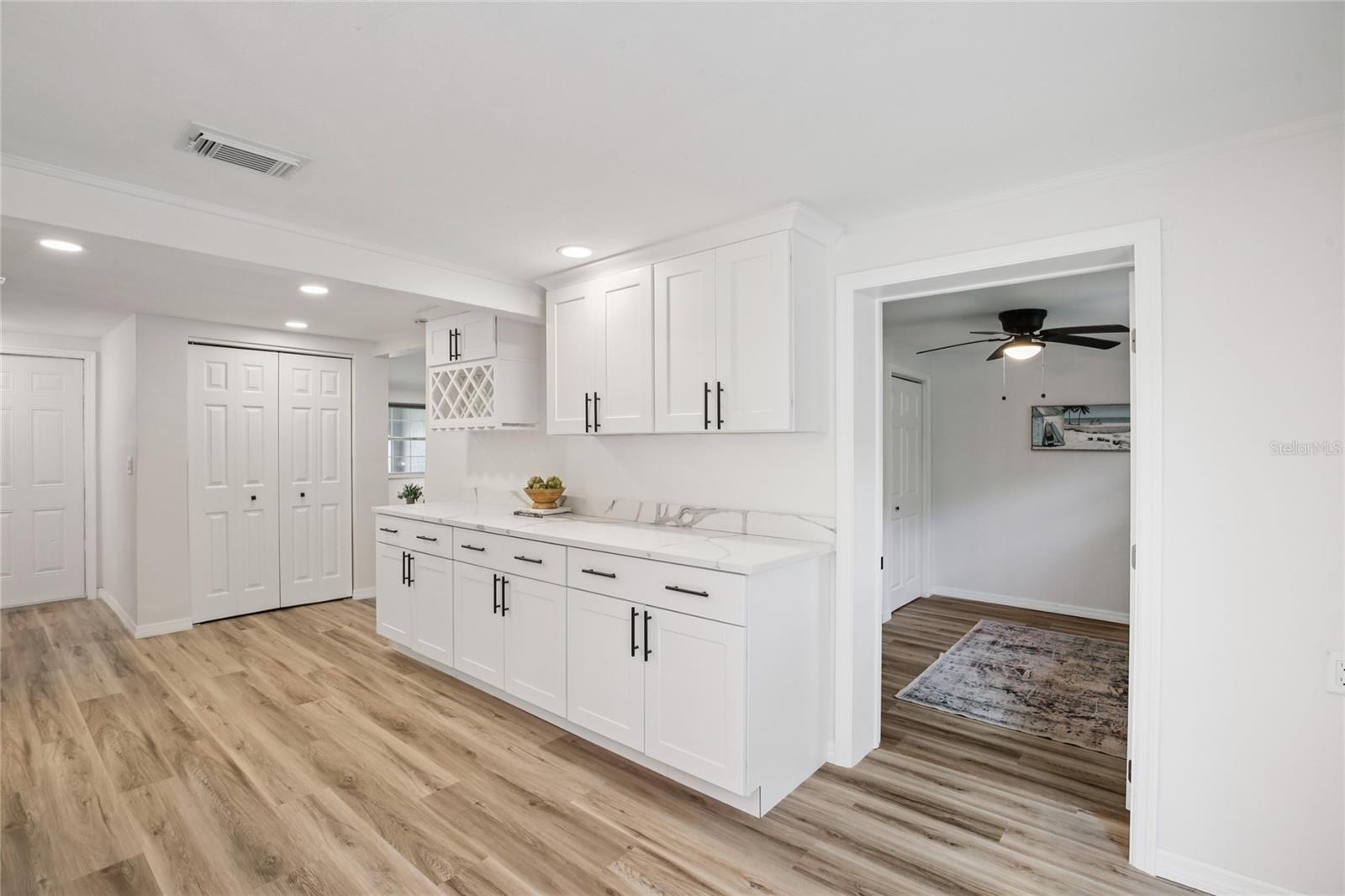 Additional cabinetry, wine rack and counterop space