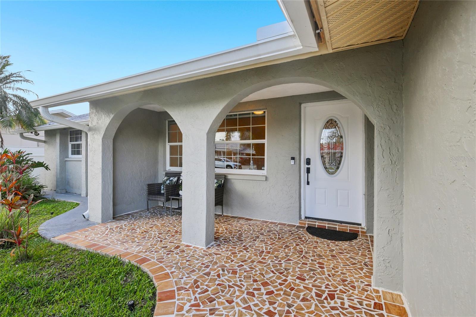 Covered entry with mosaic tile path
