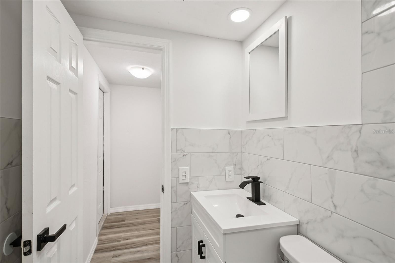 Updated bathroom with modern fixtures and tiled shower