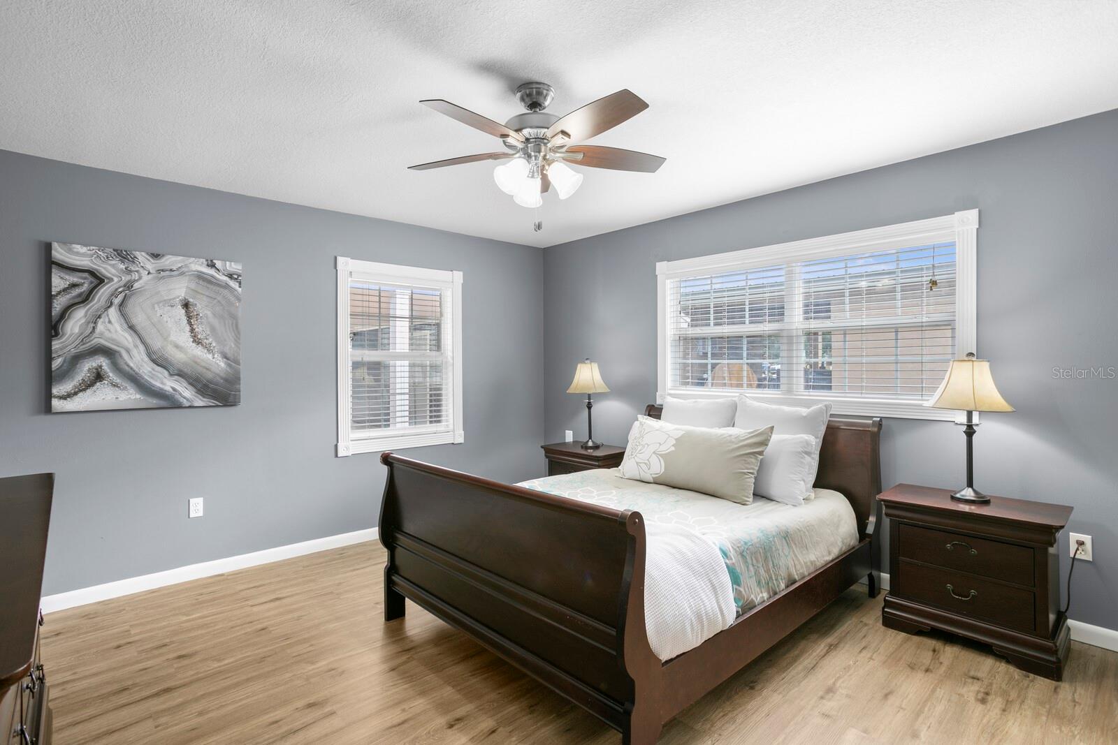 Primary suite has luxury vinyl plank flooring & ceiling fan