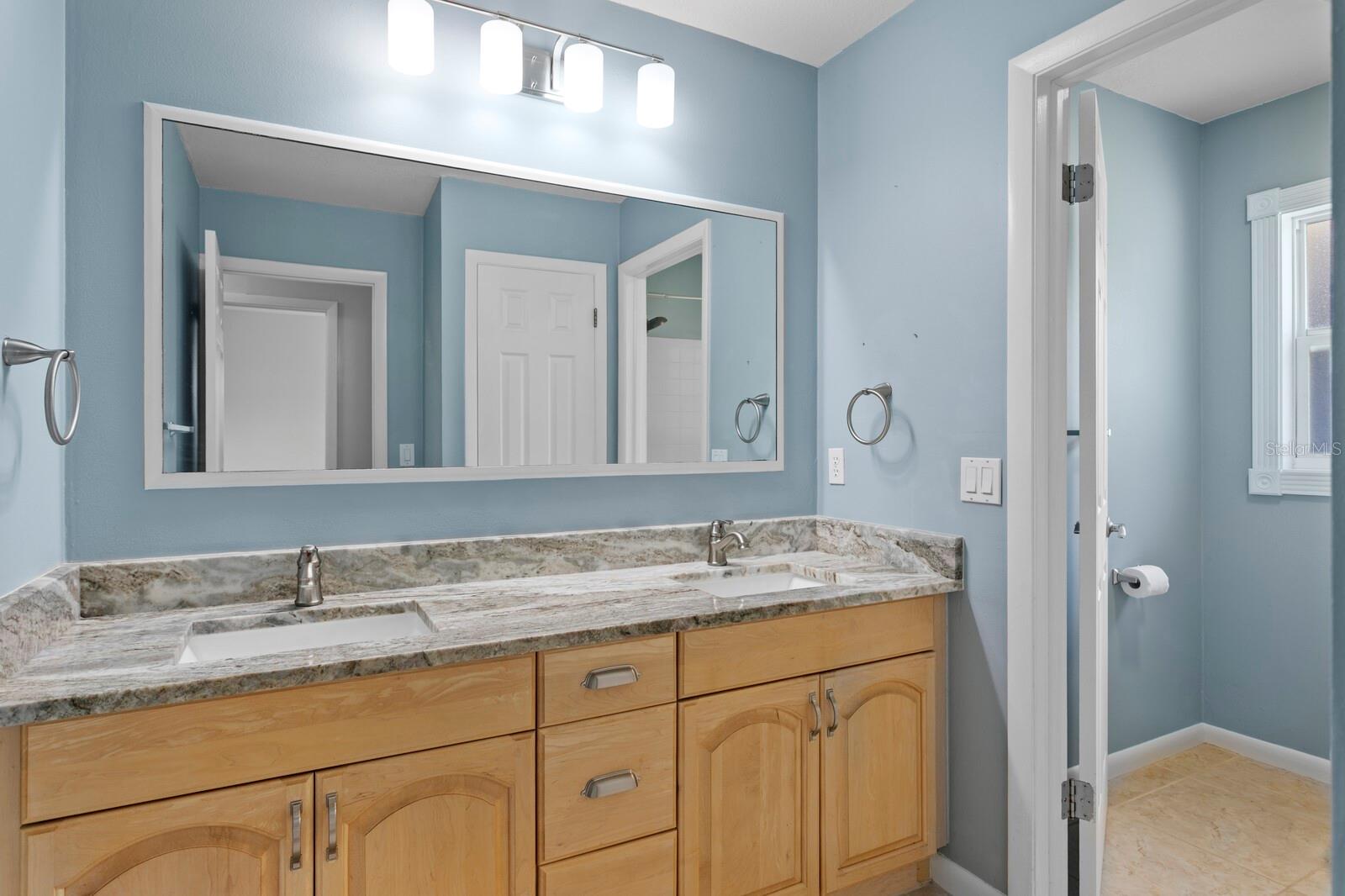 2nd Full Bath shared by the 2nd and 3rd bedroom and includes granite counters and a tub/shower combo