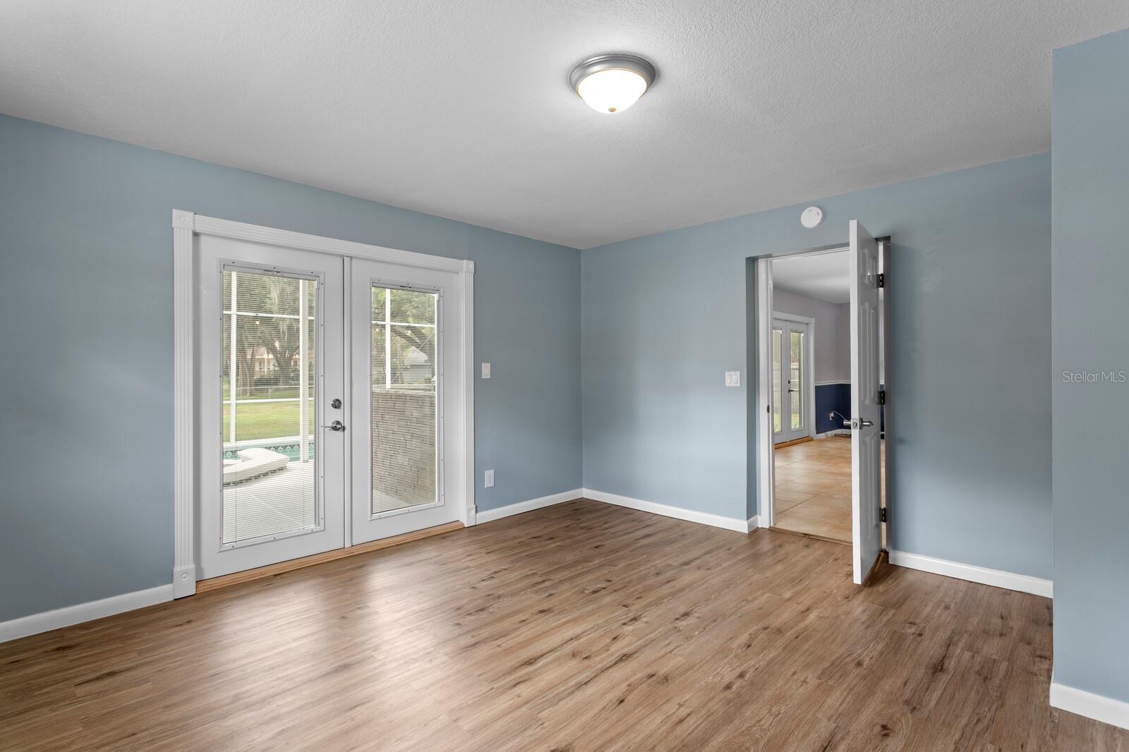 4th bedroom with French doors leading out to the private pool