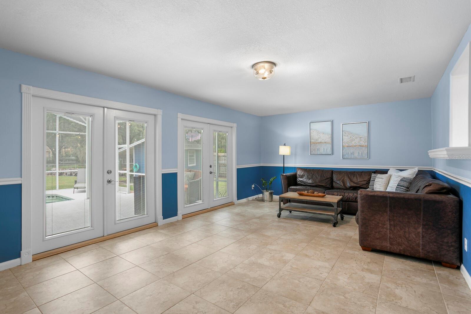 Pool and lake views from the large family room with dual sets of French doors