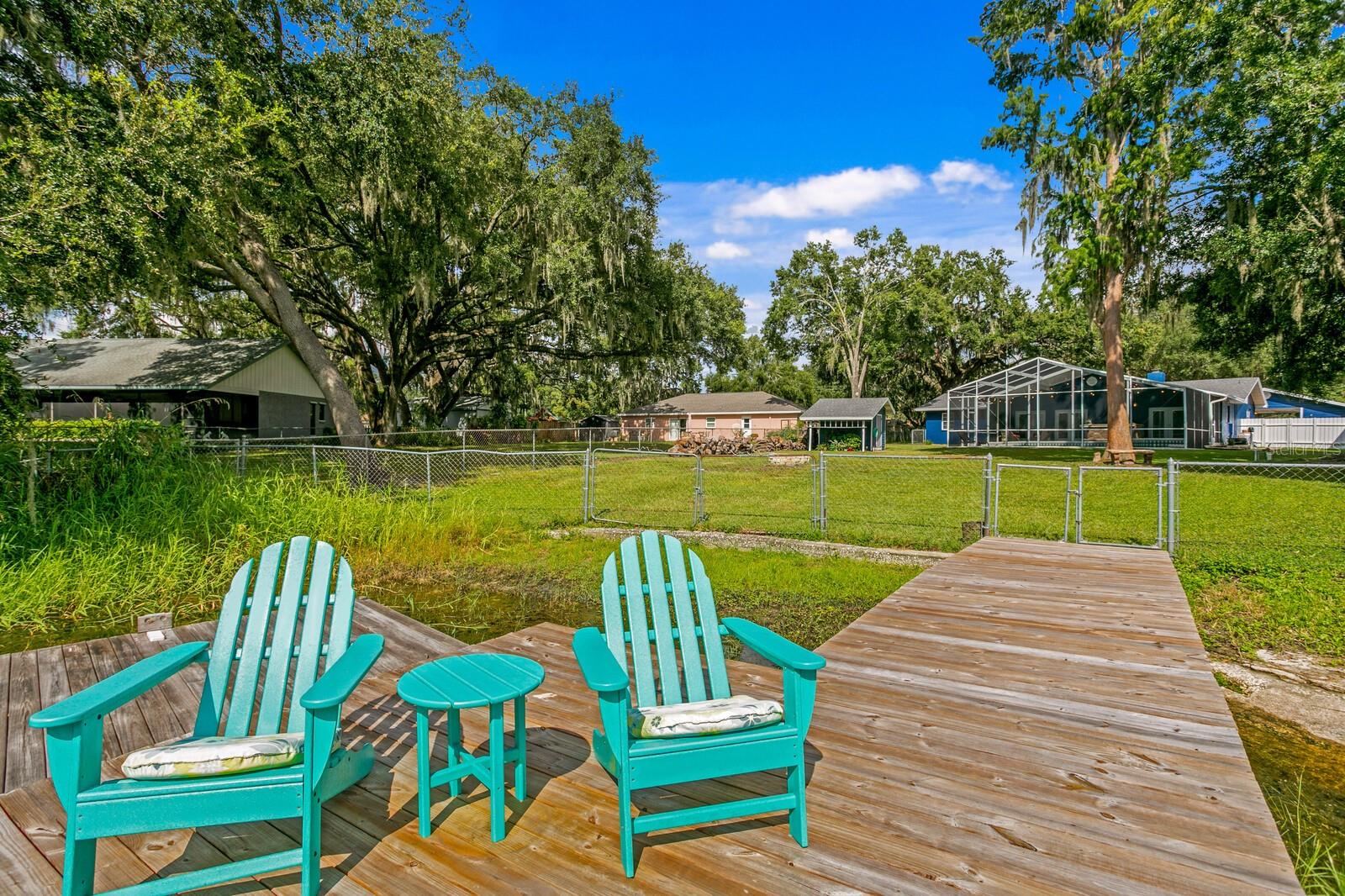 Fenced backyard leads to private dock