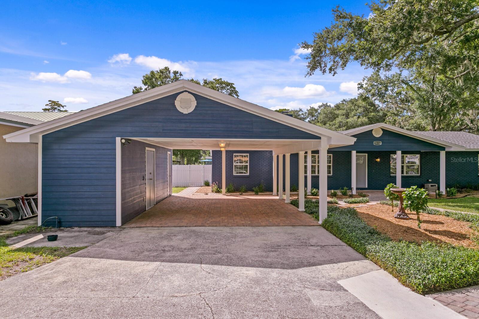Oversized 2-car carport with side storage area.  Can be easily converted into a 2-car garage.