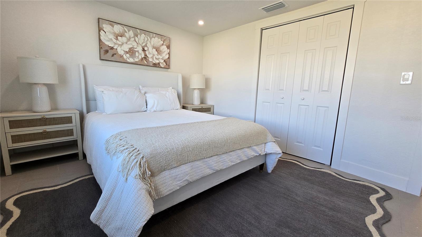 Master bed. picture and night stands come with the house