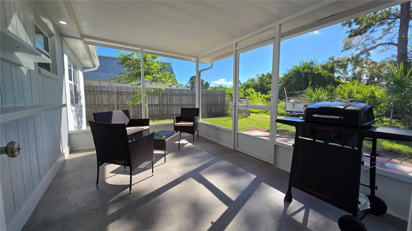 Screened in backyard patio with Grill