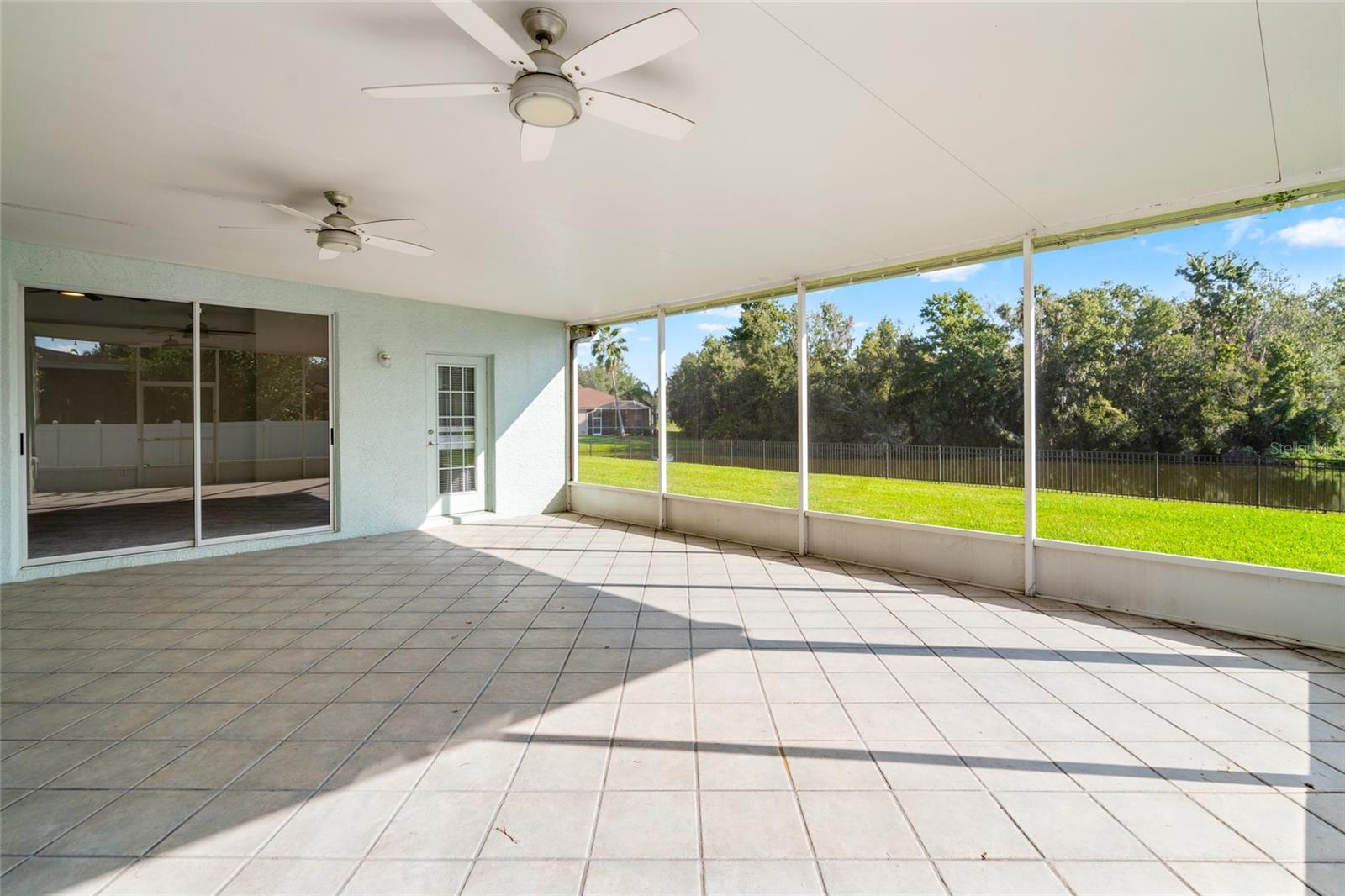 Screened Lanai with full view of Pond and Yard