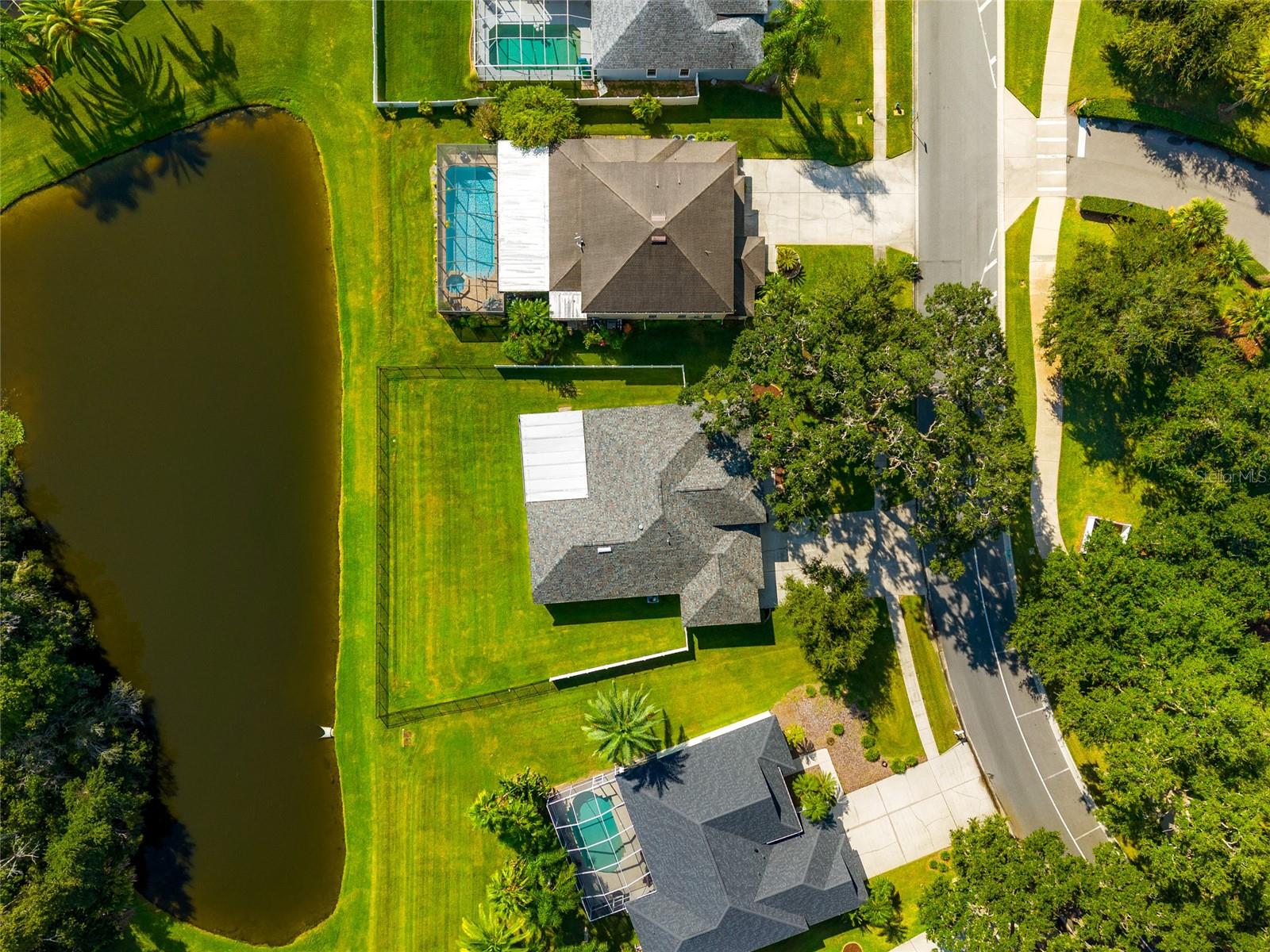 Overhead view of the lot, home and pond