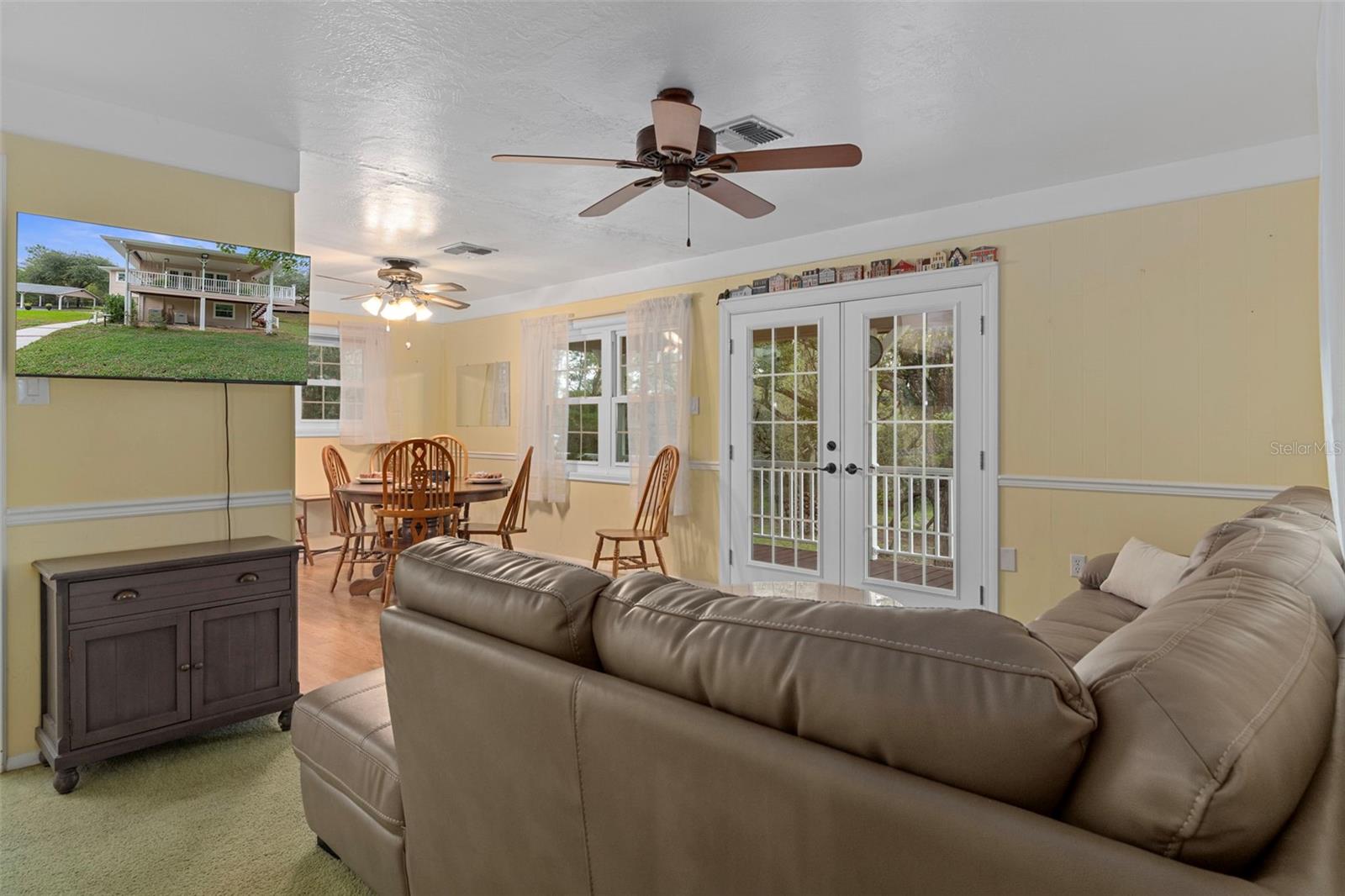 Upstairs living room to balcony and dining