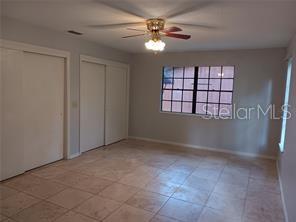 huge master BR with expensive travertine flooring, fan and 2 closets