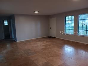 living rm with expensive travertine flooring...