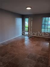 living rm with expensive travertine flooring...