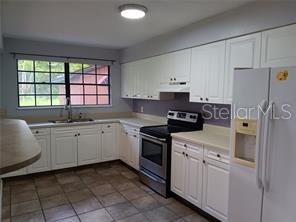 beautiful cabinets with stainless steel pull-down faucet with light and sink.