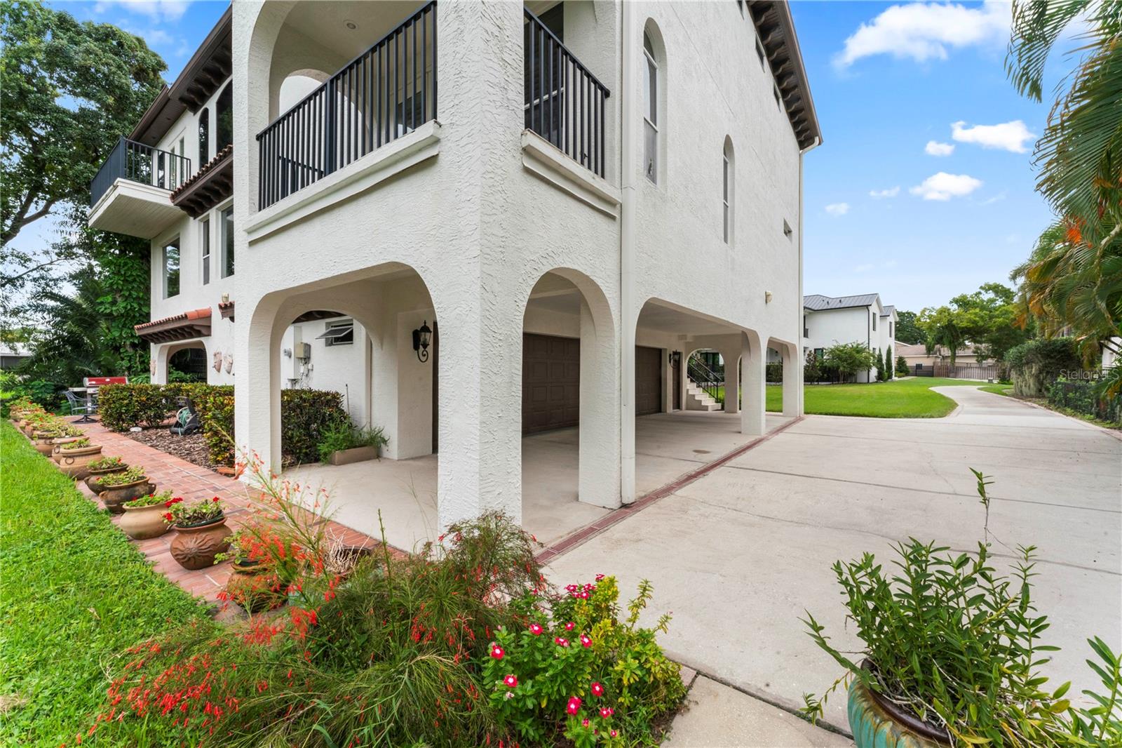 Rear Yard With View of The Garages and Driveways