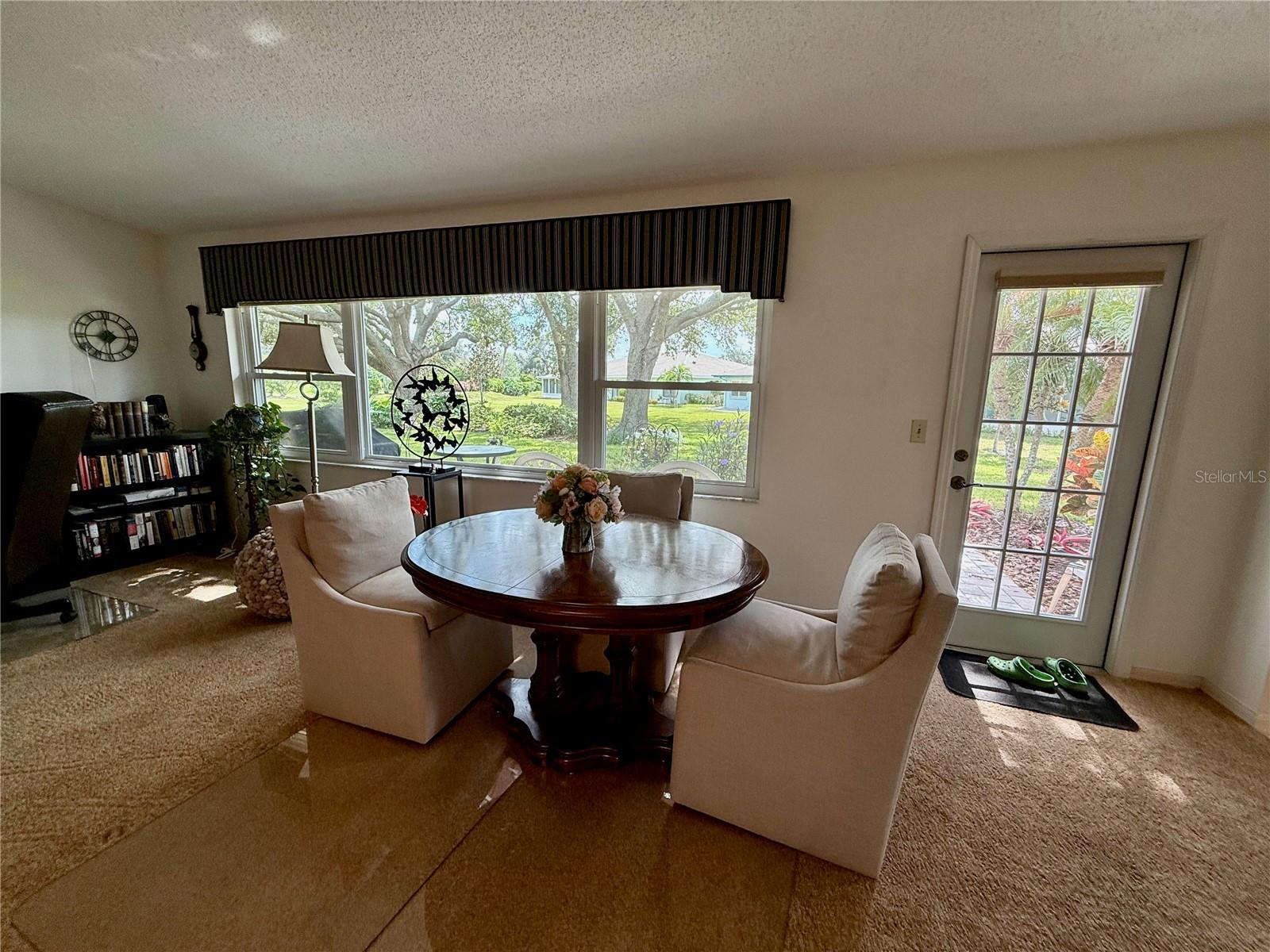 Formal dining or extended living space with view of back yard