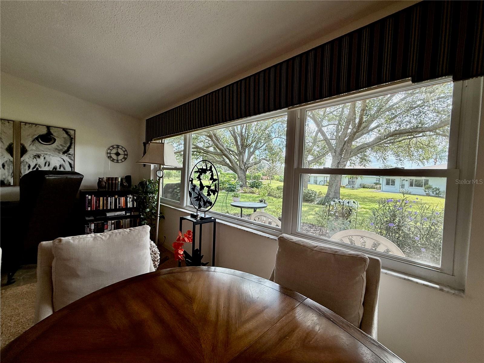 Florida room being used as a dining area and office.   The large window provides lots of natural light throughout the house