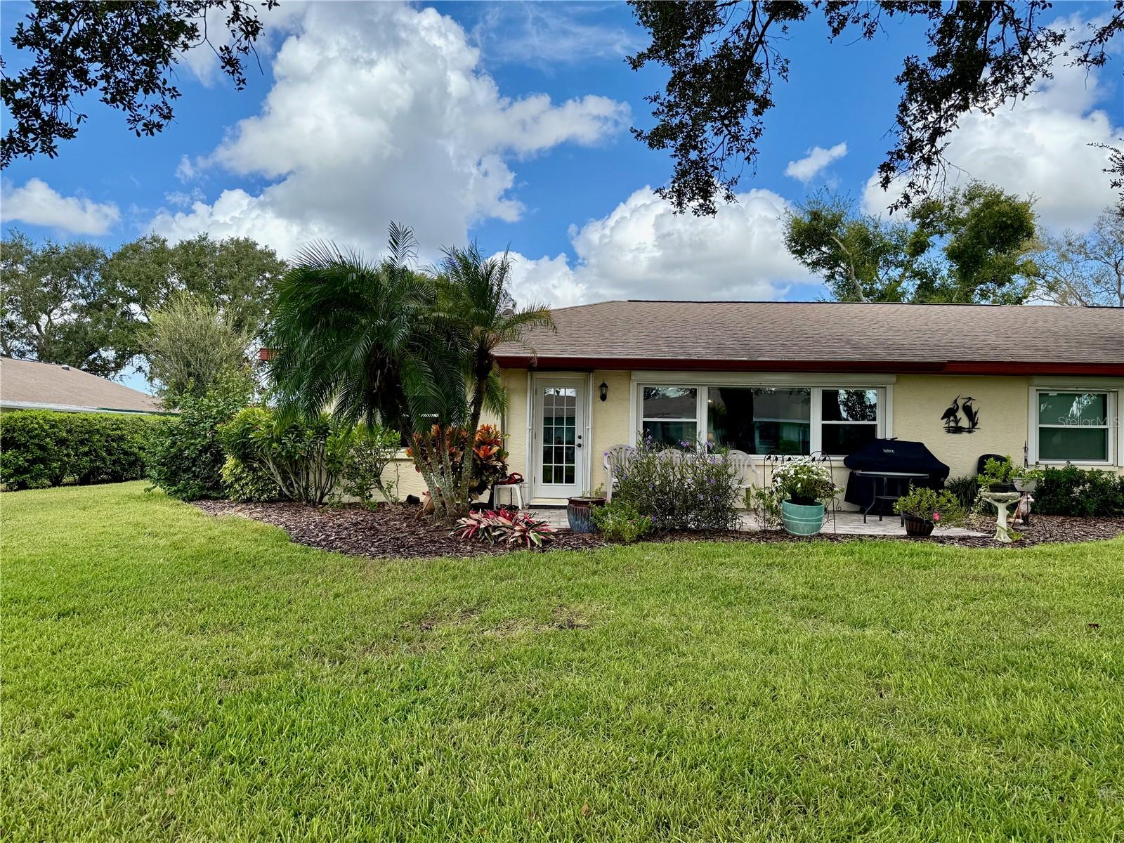 View of the back of the property which has mature landscaping