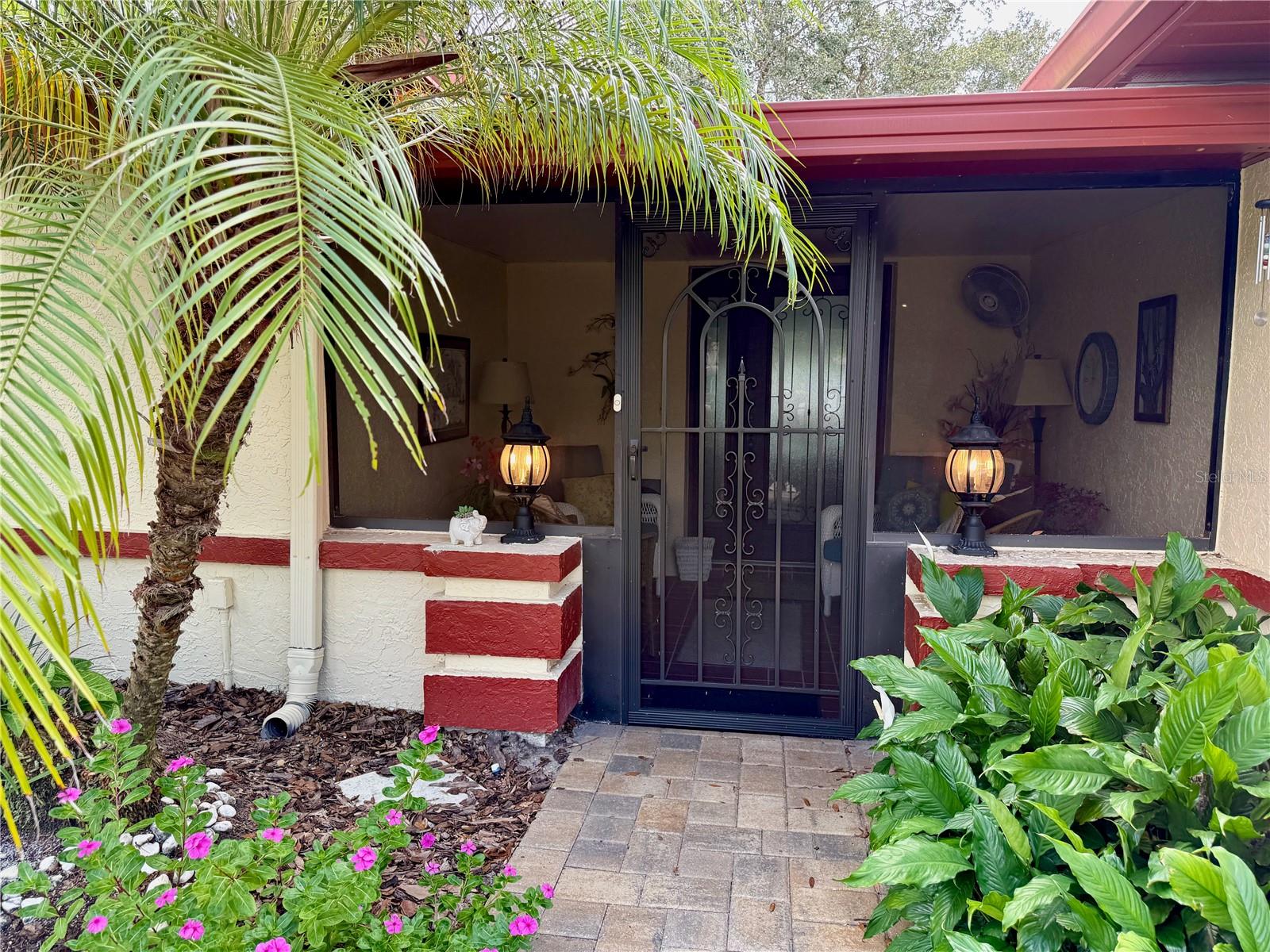 Beautiful entrance surrounded by lush landscaping