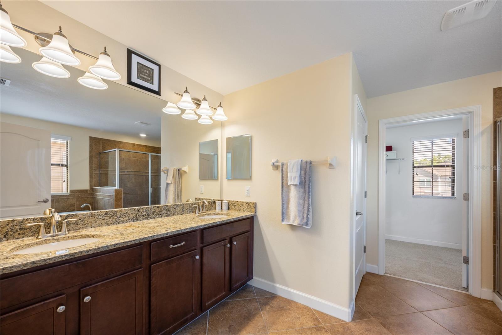 Primary Bathroom with Granite Countertops and Double Sinks