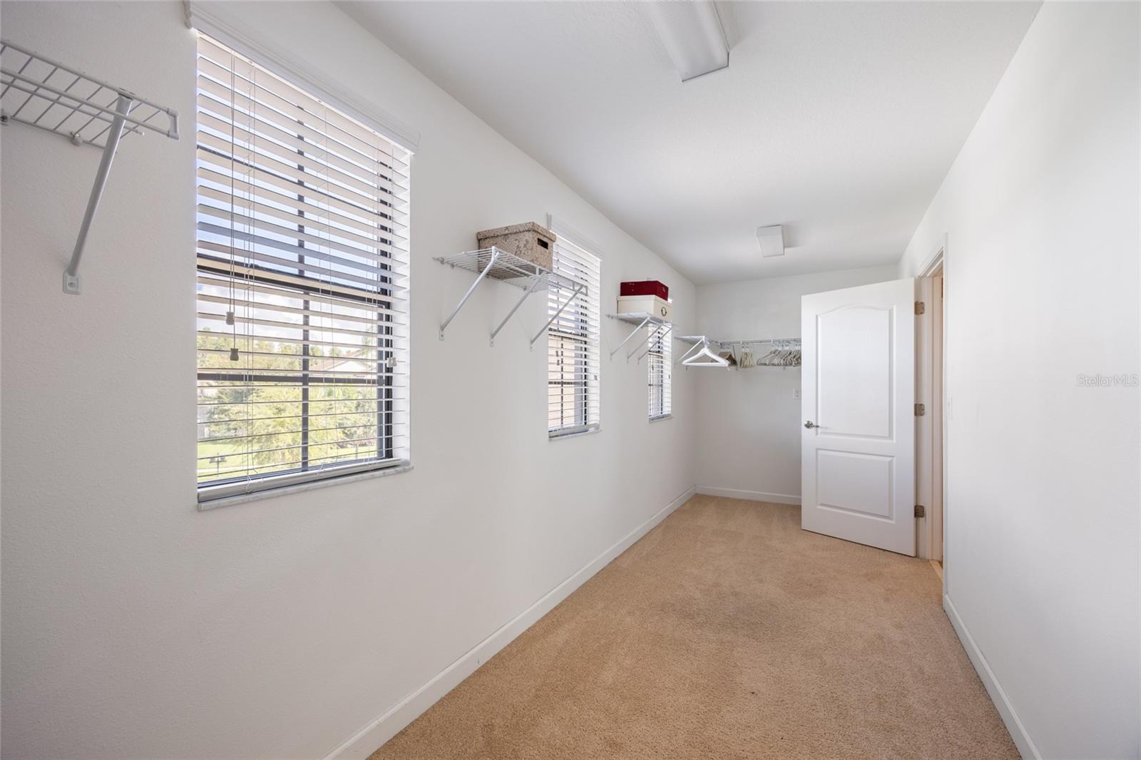 Spacious Primary Bedroom Closet with Natural Lighting