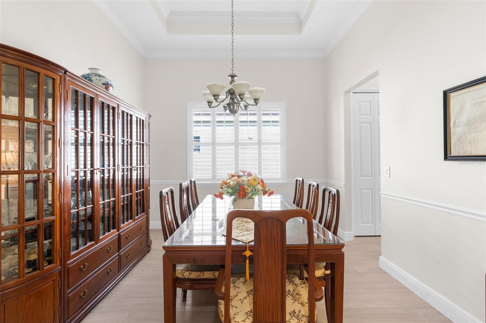 Large formal dining room with tray ceiling.