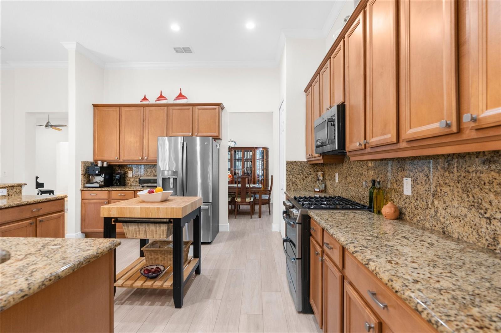 Large open kitchen with granite countertops, real wood cabinets and "Profile" GE appliances.
