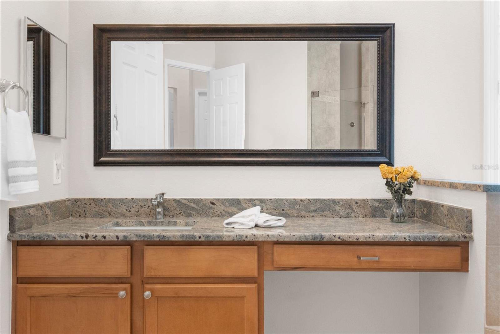 Master suite: "Her" bath area with level-3 granite countertop and private wet closet.