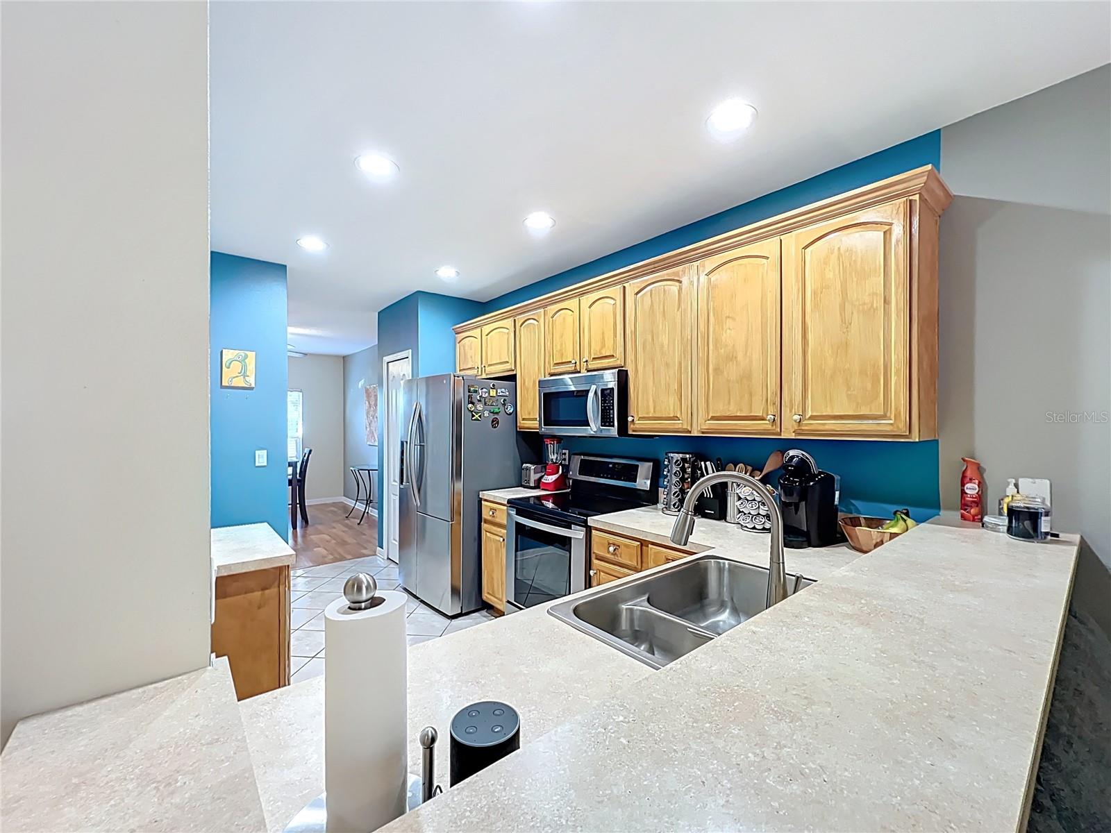 Kitchen area with bar overlooking familyrooom