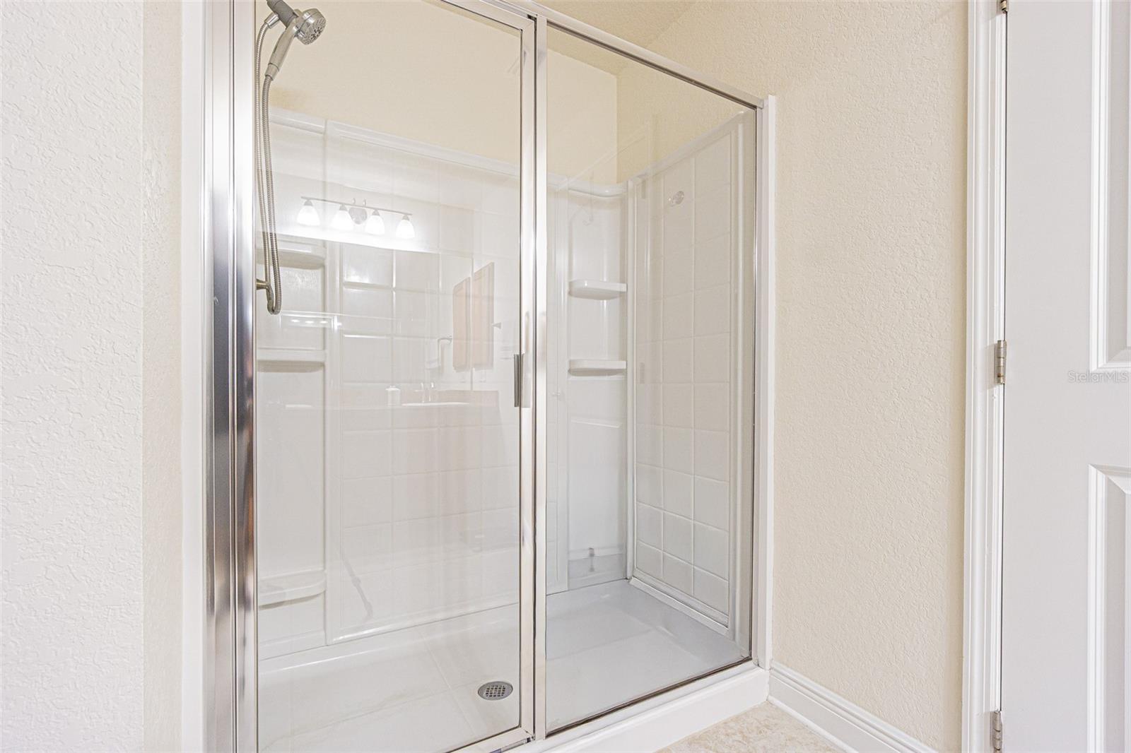 Interior laundry room with storage above