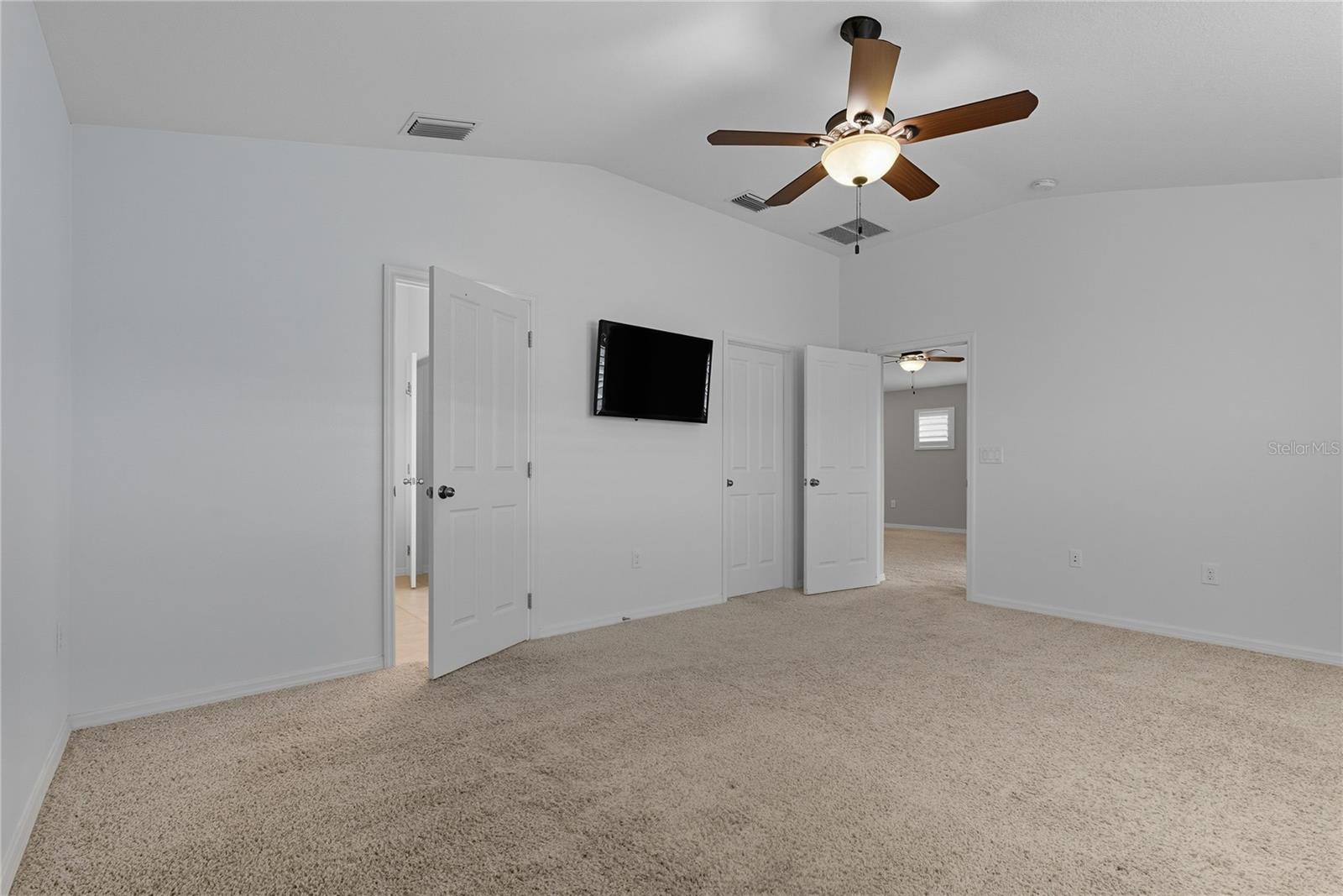 Primary Bedroom - Primary Bedroom (left) - Primary Walk-In Closet (right)