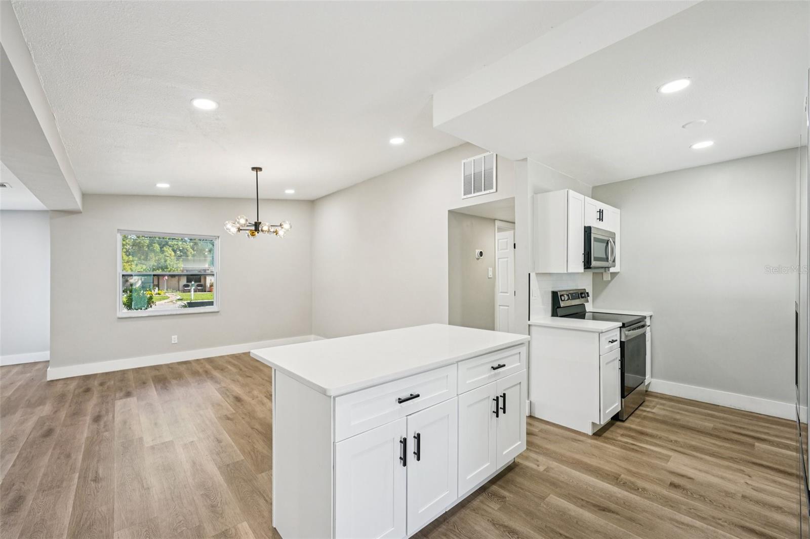Kitchen overlooks dining area and living room